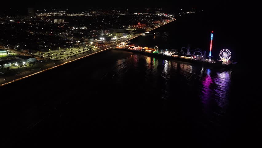 Houston, Texas, United States, USA, November 2025, night, nighttime, amusement park, amusement pier, pier, waterfront, coastline, Gulf Coast, Ferris wheel, roller coaster, thrill ride, fairground, carnival rides, entertainment, leisure, tourism, travel destination, city lights, neon lights.