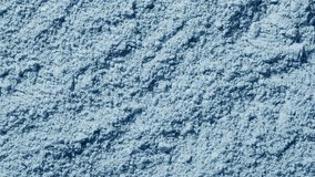 Overhead frame of pale blue natural powder texture highlighted by rotating light forming changing shadows - Powered by Shutterstock - Get 15% off with code: PIKWIZARD15
