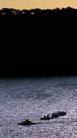 Silhouette of People on Kayaks