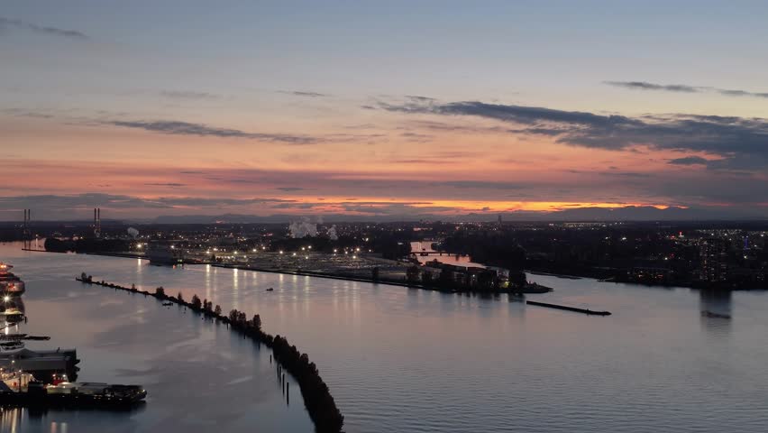 Spectacular Sunset Over Fraser River and New Westminster Cityscape in British Columbia, Canada
