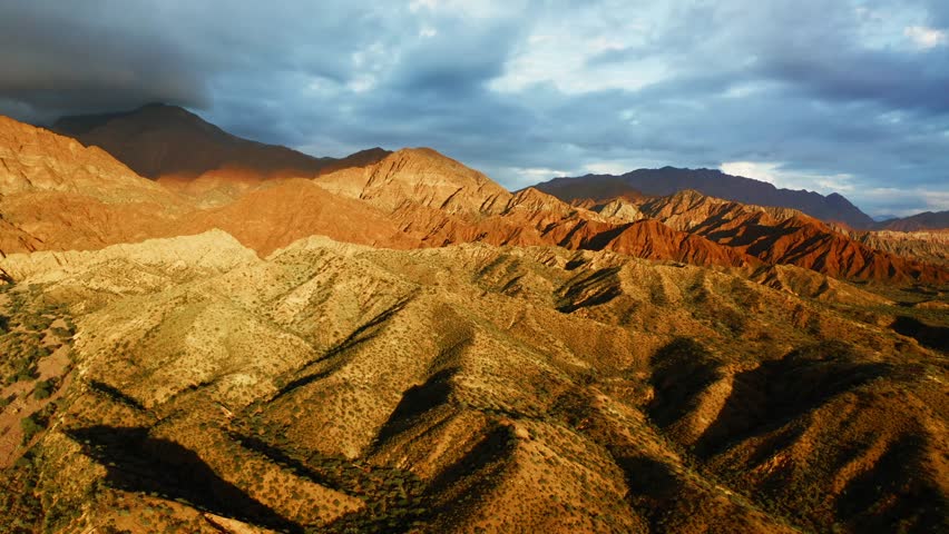 Layered hills and eroded ridges define Fiambala high desert landscape beneath wide open sky
