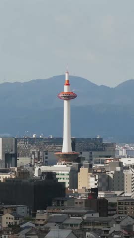 Vertical Aerial establishing fly Japan Kyoto city Tower buildings urban cityscape