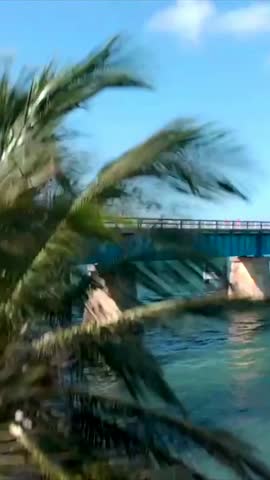 Aerial view of Seven Mile Bridge in Florida Keys with cars driving over turquoise ocean water