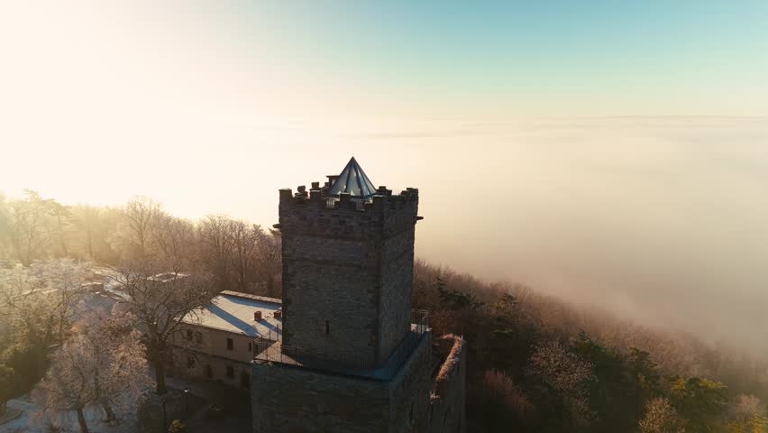 A Castle in Germany at a sunny winter morning with low hanging clouds