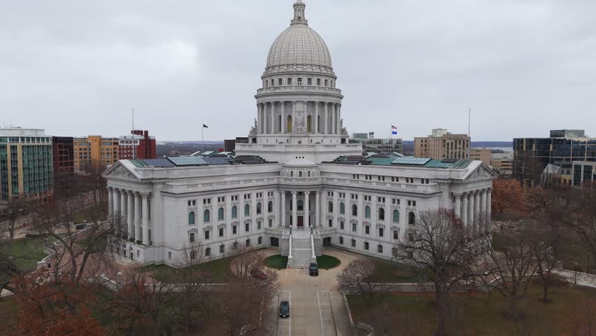 aerial of Madison, Wisconsin, highlighting the State Capitol building and the dense cityscape around it.