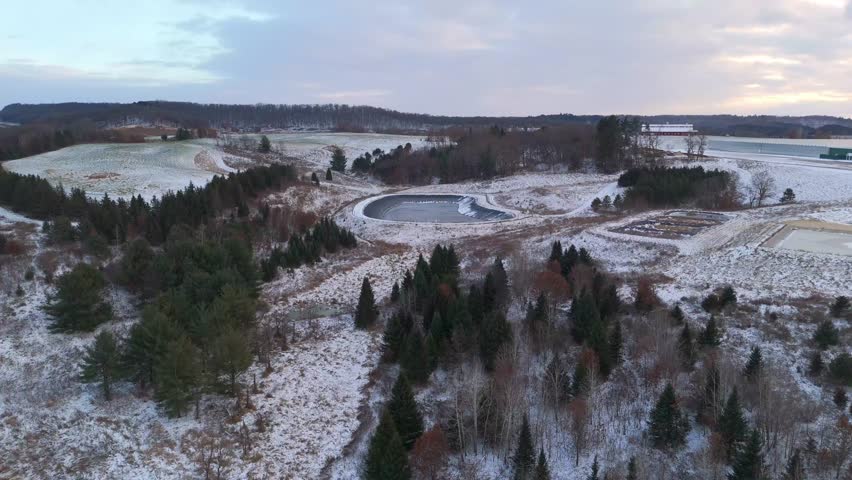 Aerial scene of the Wisconsin countryside coated in snow, capturing the calm, open expanse of rural winter scenery.