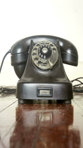 vintage black phone on a old wooden floor 