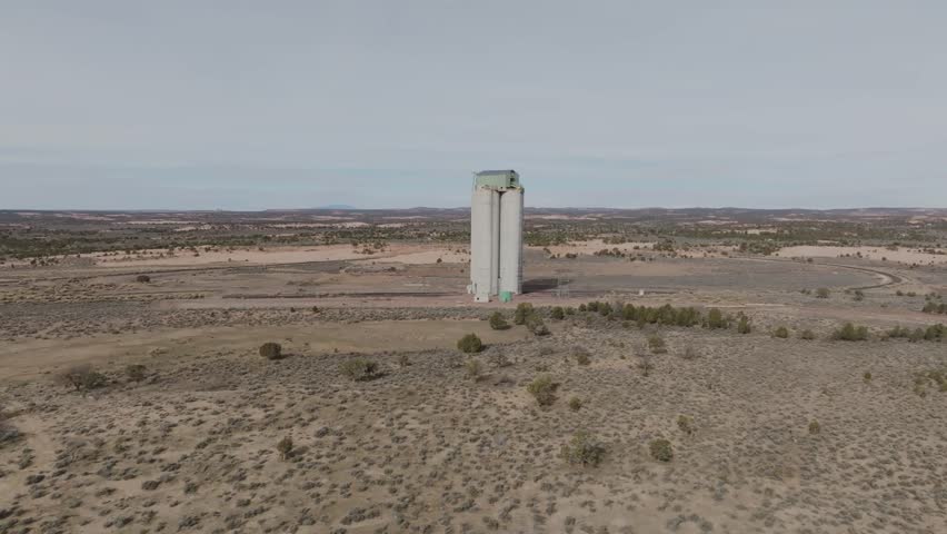 Aerial drone footage spinning right to left over the Black Mesa coal mining complex near Kayenta in northern Arizona. Industrial energy infrastructure located on Navajo Nation land American Southwest.