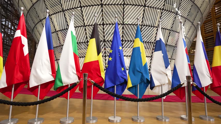 Row of EU country flags in the European Council building in Brussels, Belgium - Low angle tracking shot