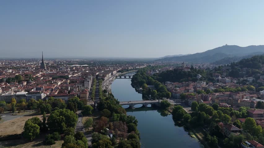Aerial view of the Fiume Po river meandering through the city, reflecting the skyline with its buildings, Turin, Piedmont, Italy.