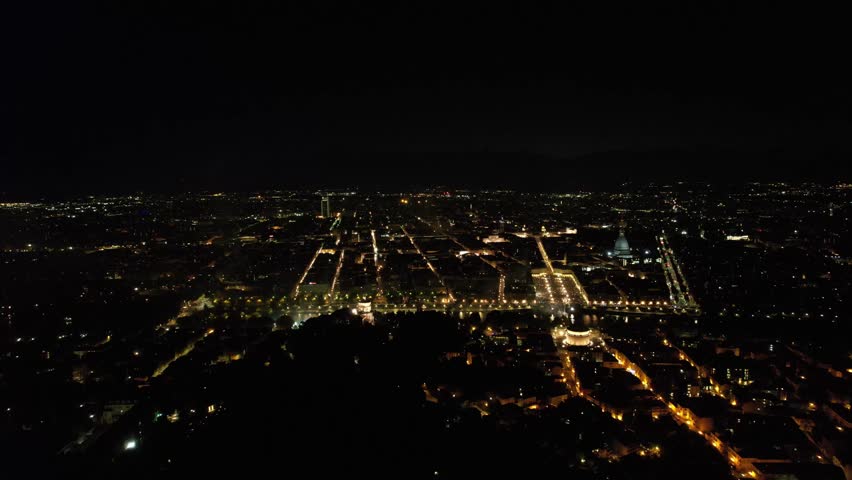 Aerial view of vibrant fireworks illuminating the night sky above the Mole Antonelliana and the city lights below, Torino, Piemonte, Italy.