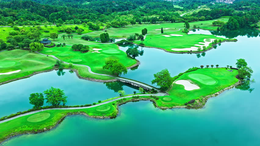 Aerial shot of the beautiful green golf course and blue river with green forest natural landscape in summer