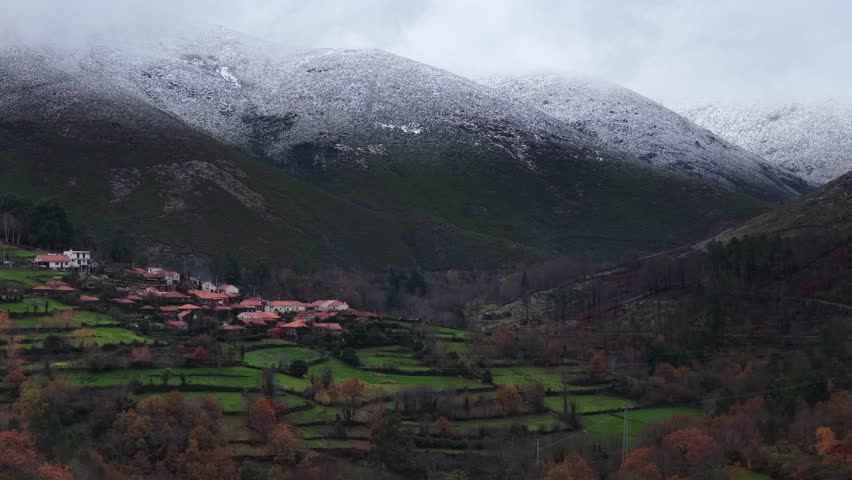 Portuguese village surrounded by snow in the mountains drone flying forward