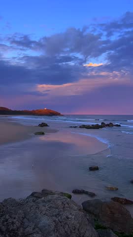 Cinematic Sunset over a Sandy Beach with Purple and Orange Clouds