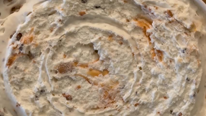 Closeup of Scooping Peanut Butter Ice Cream Out of a Container