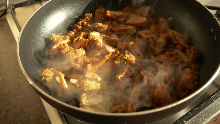 Homemade Fried Meat Cooking with Steam in Warm Afternoon Light