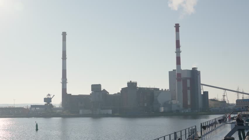 Oil terminal operations with industrial buildings and smokestacks
