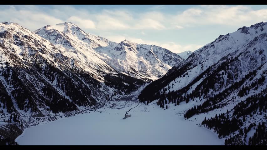 majestic snow-capped mountains, snow-covered lake reservoir