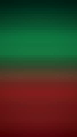 Vertical abstract footage showing a split screen effect with green and red color blocks blending in the center. This minimalist background features a smooth gradient transition and a modern, dual-tone aesthetic, perfect for mobile video comparisons, social media polls, and duality concepts.
