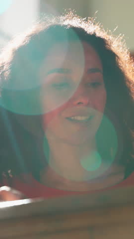 Hispanic Latina student girl smiling writing exam in sunny university auditorium positive woman female lady studying learning write task in academy big sitting in college lecture lesson class sunbeam