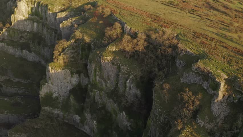 Aerial tracking along the grassy hilltops and exposed limestone cliffs of Cheddar Gorge, Somerset, UK