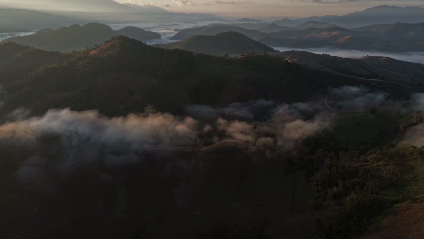 Hyperlapse video: Sunrise with thick fog over mountaintops.