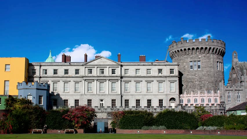 A low-angle shot of the Dublin Castle in Ireland - a major Irish government complexFrom below shot of medieval monumental building of tower and Chapel Royal under blue cloudy sky, DublinDUBLIN, IRELAND - Aug 16, 2025: Dublin Castle serves as a major historic and cultural landmark in Ireland, featuring centuries of architectural and political heritage.