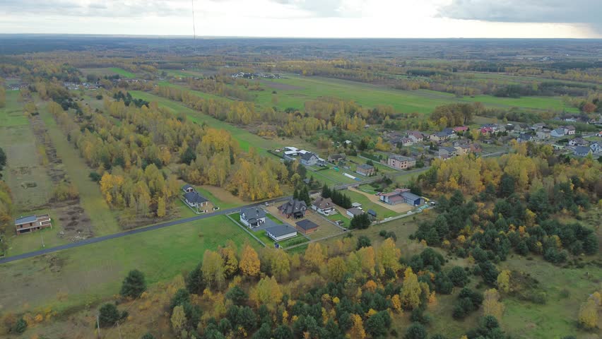 Aerial view of peaceful homes and fall forest