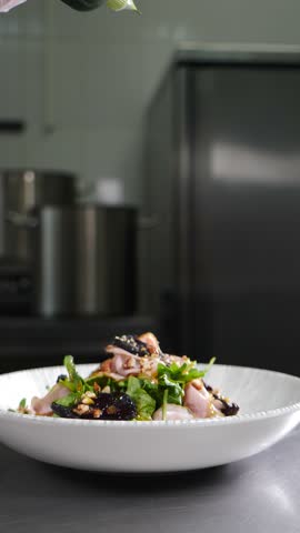 Dressing being poured over fresh salad. Healthy vegetarian dish. Highlighting the rich, savory sauce drizzling over crisp, colorful salad. Restaurant food cooking. Vertical 4 k video