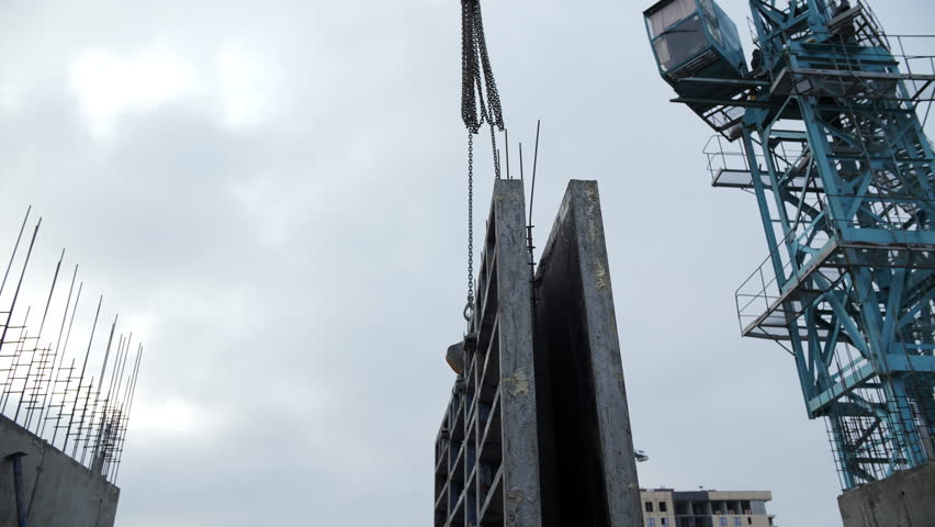 Tower crane lifting vertical concrete formwork panel