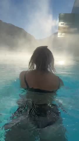 Woman in swimming pool outdoors in winter