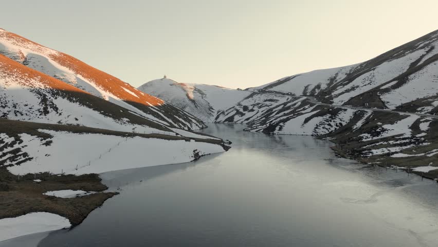Breathtaking 4K Aerial View of Snow Covered Mountain Peak Winter Landscape