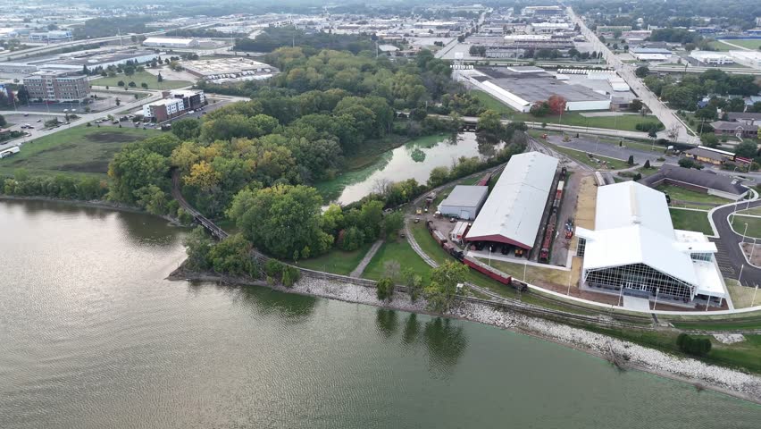 Left to right shot of Fox River in Green Bay Wisconsin USA.  Aerial shot of Railroad Museum and industrial area.  Silver light reflects off the river at dusk.