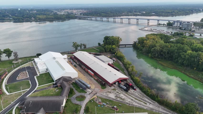 Orbital of Fox River in Green Bay Wisconsin USA.  Aerial shot of Railroad Museum and bridge.  Silver light reflects off the river at dusk.