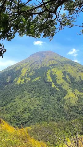 Lush Green Mountain Landscape Under Blue Sky