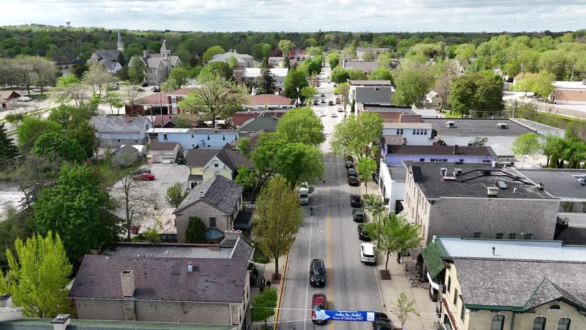 Aerial of Cedarburg Wisconsin USA on Spring Day.  Push shot with focus on Main Street with clouds overhead.
