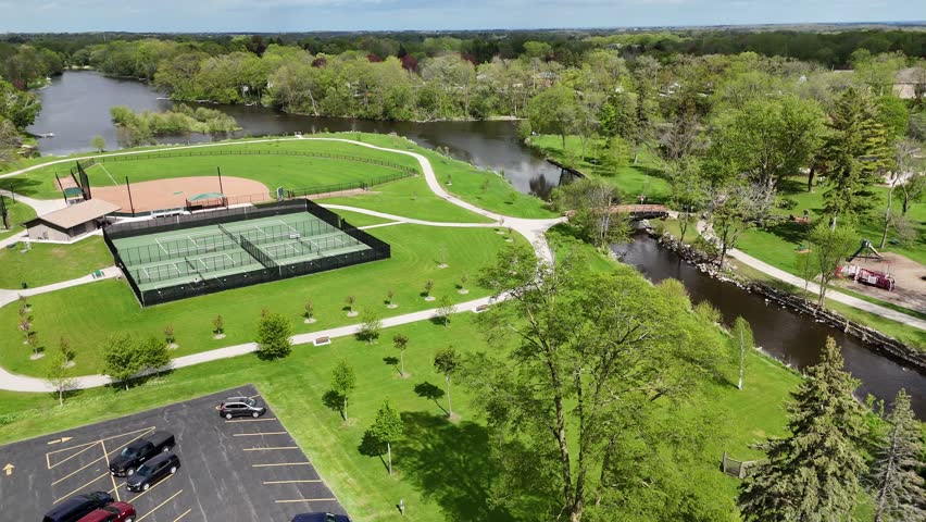 Aerial of Cedarburg Wisconsin USA on Spring Day.  High shot of park and river with Pickleball courts.