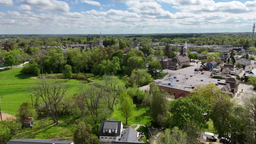 Aerial of Cedarburg Wisconsin USA on Spring Day.  Spinning Shot showing small town and green trees.