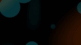 Defocussed teal bokeh circles on black background with warm orange flare effect
 - Powered by Shutterstock - Get 15% off with code: PIKWIZARD15