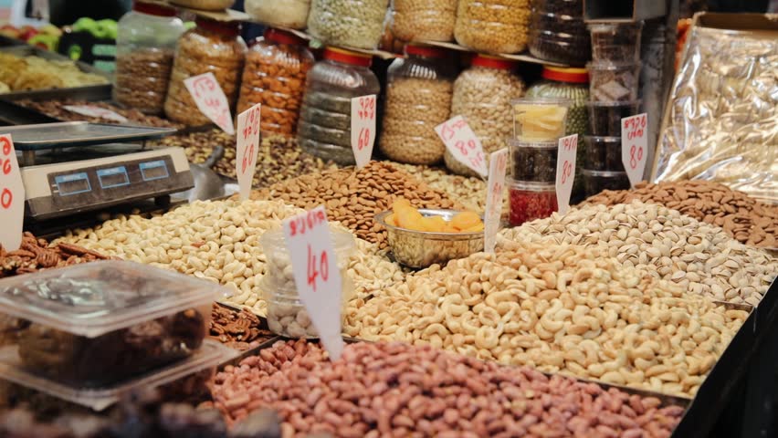 Pine nuts and pistachios is on the sale in market. Different types of nuts for sale in market of Tel Aviv, Israel