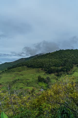 Clouds drifting over mountain slopes