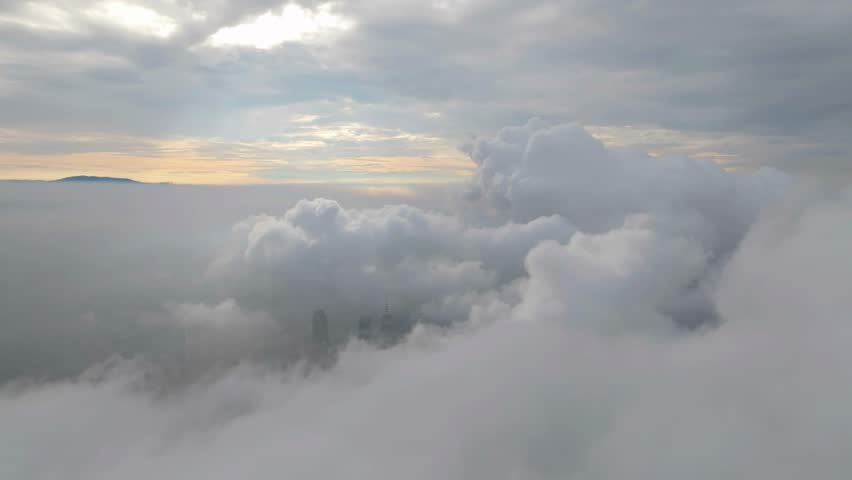 A lone skyscraper pierces through the clouds, its spire rising above the mist—where architecture meets the atmosphere in a surreal dance of steel and sky