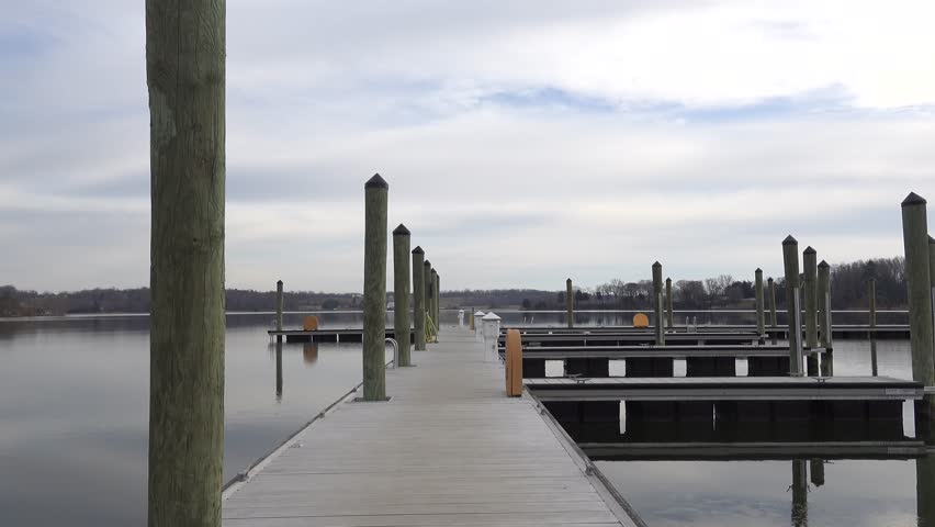 Leonardtown, Maryland USA A man walks on a public boat pier in the Leonardtown Wharf Park on the Potomac River in winter. 