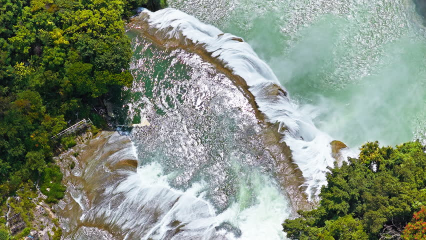 The famous Huangguoshu Waterfall natural landscape in Guizhou, China. Aerial shot of a magnificent large waterfall cascading down into a turquoise pool surrounded by lush green tropical forest in summer.