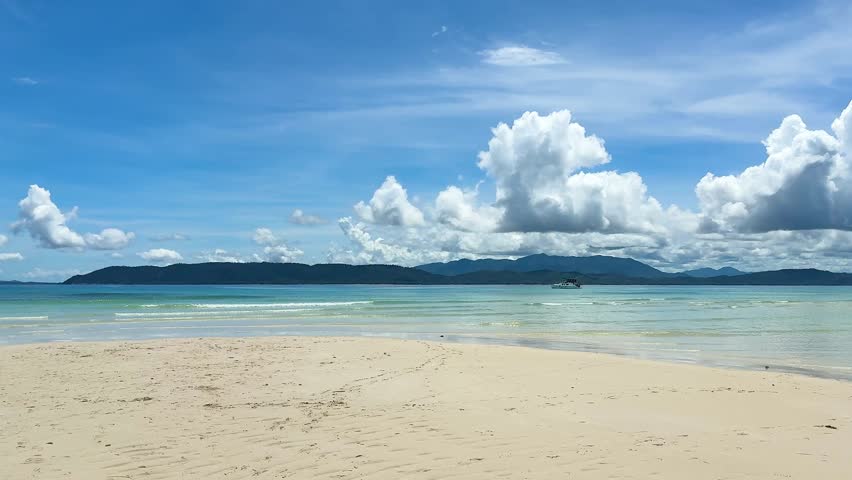Beautiful beach with clear water and clouds in the sky