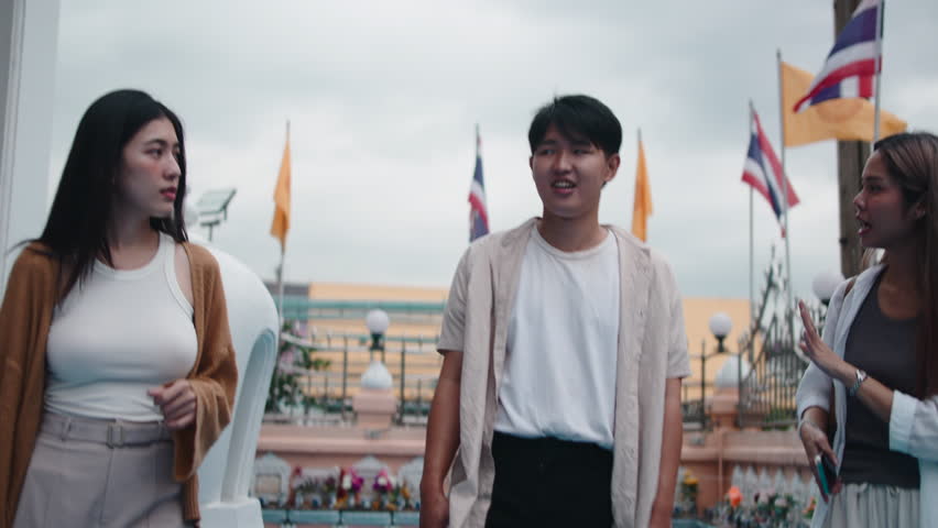 Group of asian friends talking in a thai temple