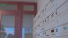 A man unlocks a mailbox and takes out his mail - closeup - Powered by Shutterstock - Get 15% off with code: PIKWIZARD15
