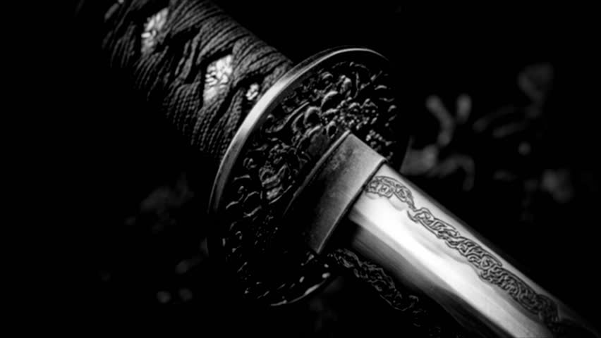 A close-up shot of a sword in black and white.. Retro video