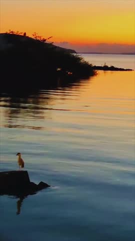 Sunset Ocean Dramatic Fiery sky over coastal rocks during sunset, showcasing vibrant colors and tranquil ocean.