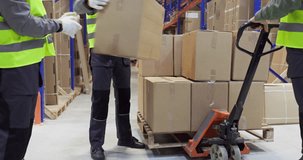 Warehouse workers loading pallet boxes for shipping. Manual pallet jack moves cartons in a distribution warehouse for efficient transport and safe loading. Strong concept of delivery logistics. - Powered by Shutterstock - Get 15% off with code: PIKWIZARD15